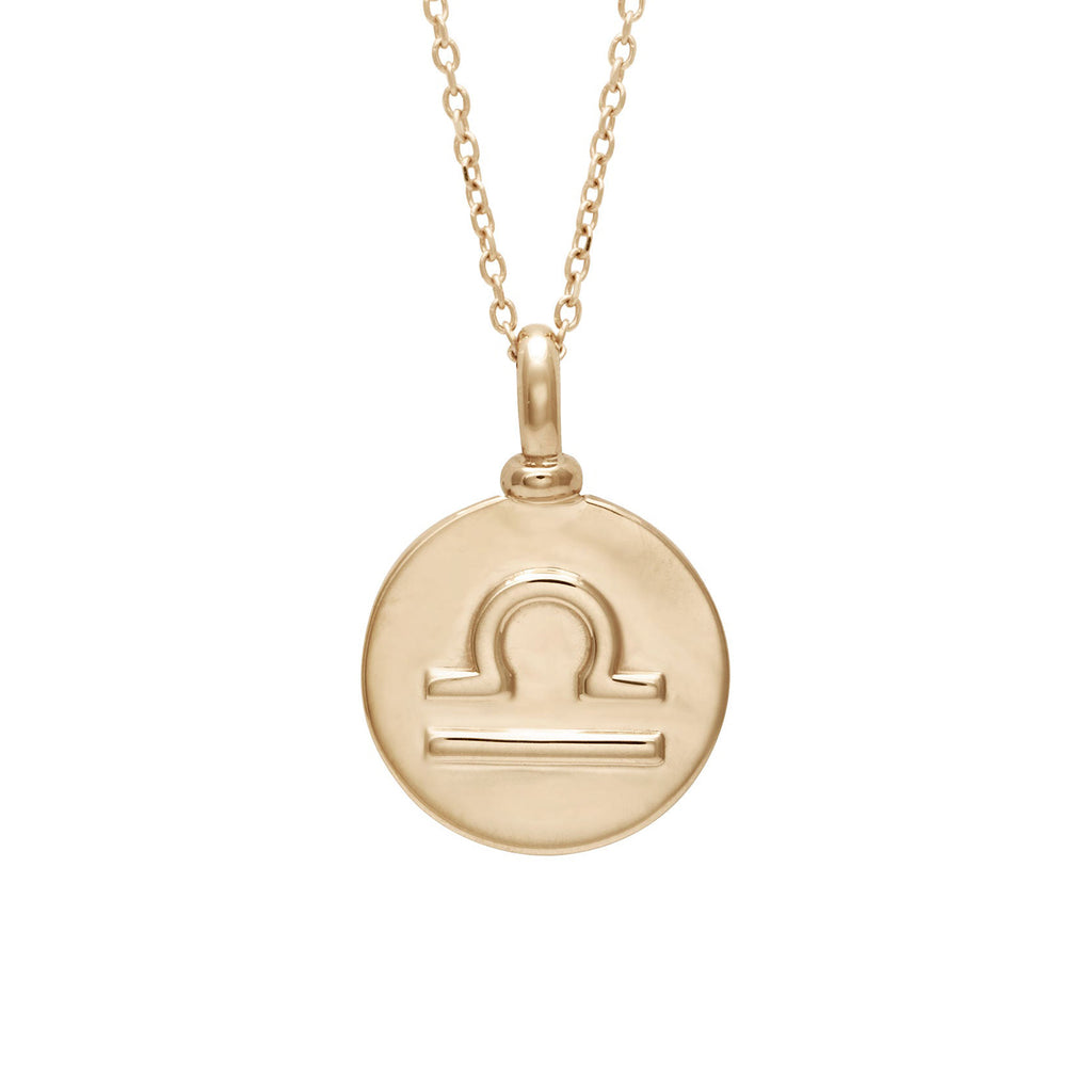 A 14mm charm with the Libra zodiac sign set in yellow gold on a yellow gold chain.