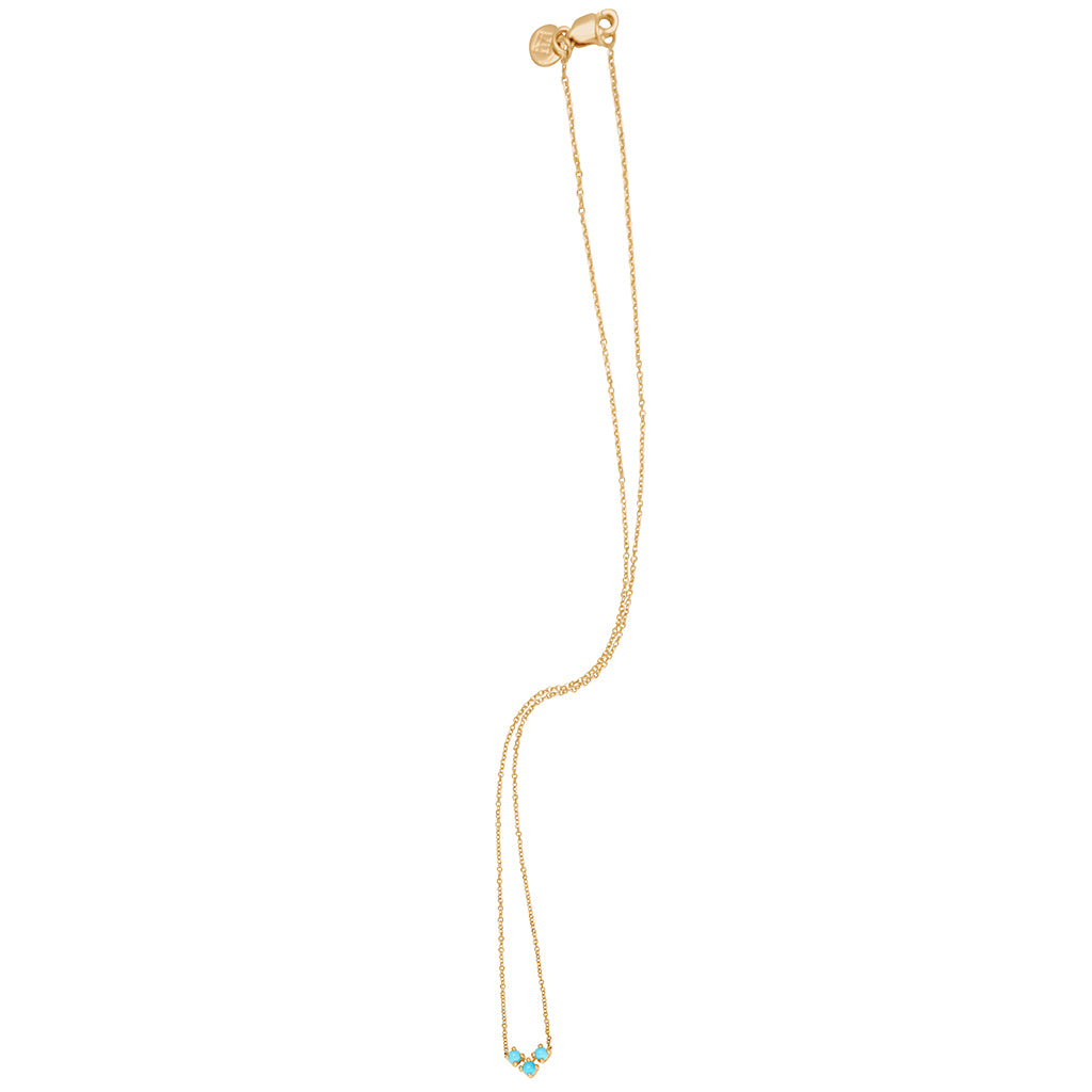 Zoomed out view of a 16" chain necklace with three turquoise stones in the shape of an arrow at the base set in yellow gold.
