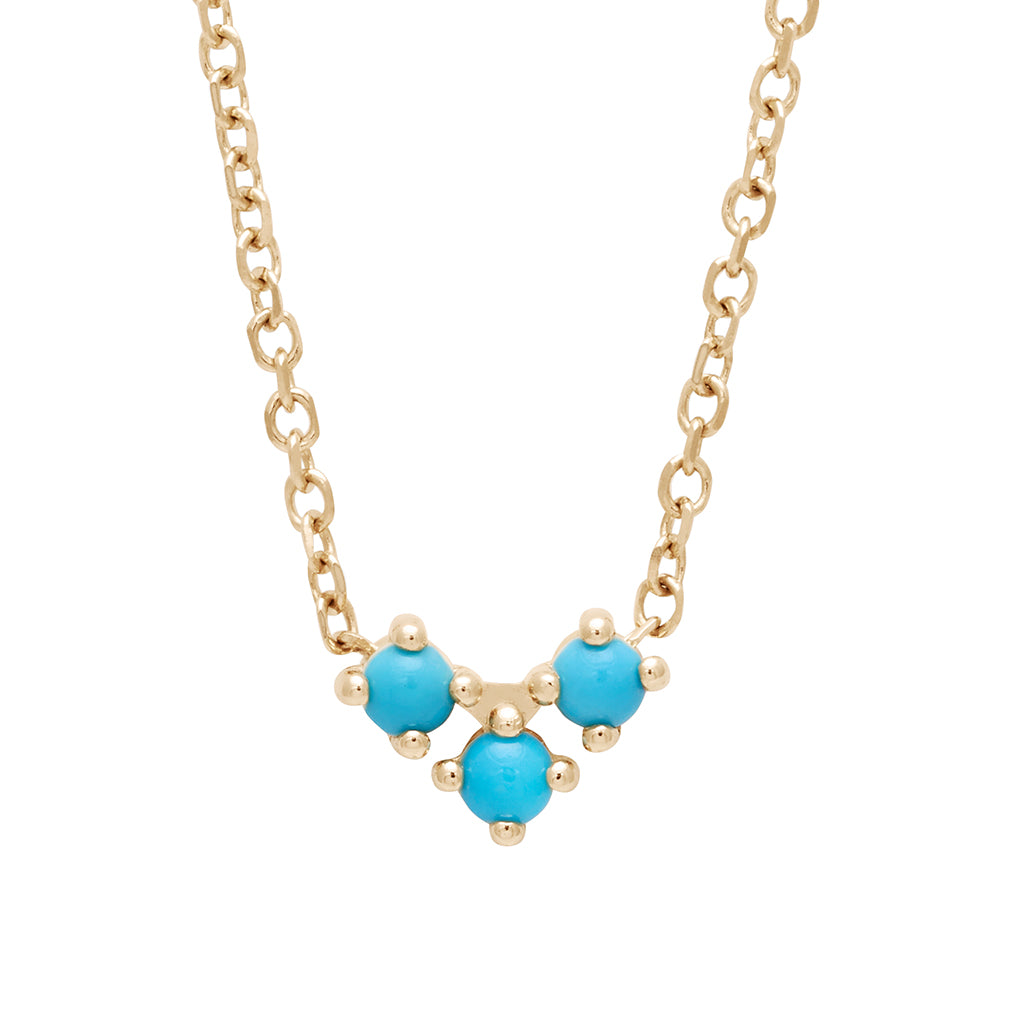A 16" chain necklace with three turquoise stones in the shape of an arrow at the base set in yellow gold.