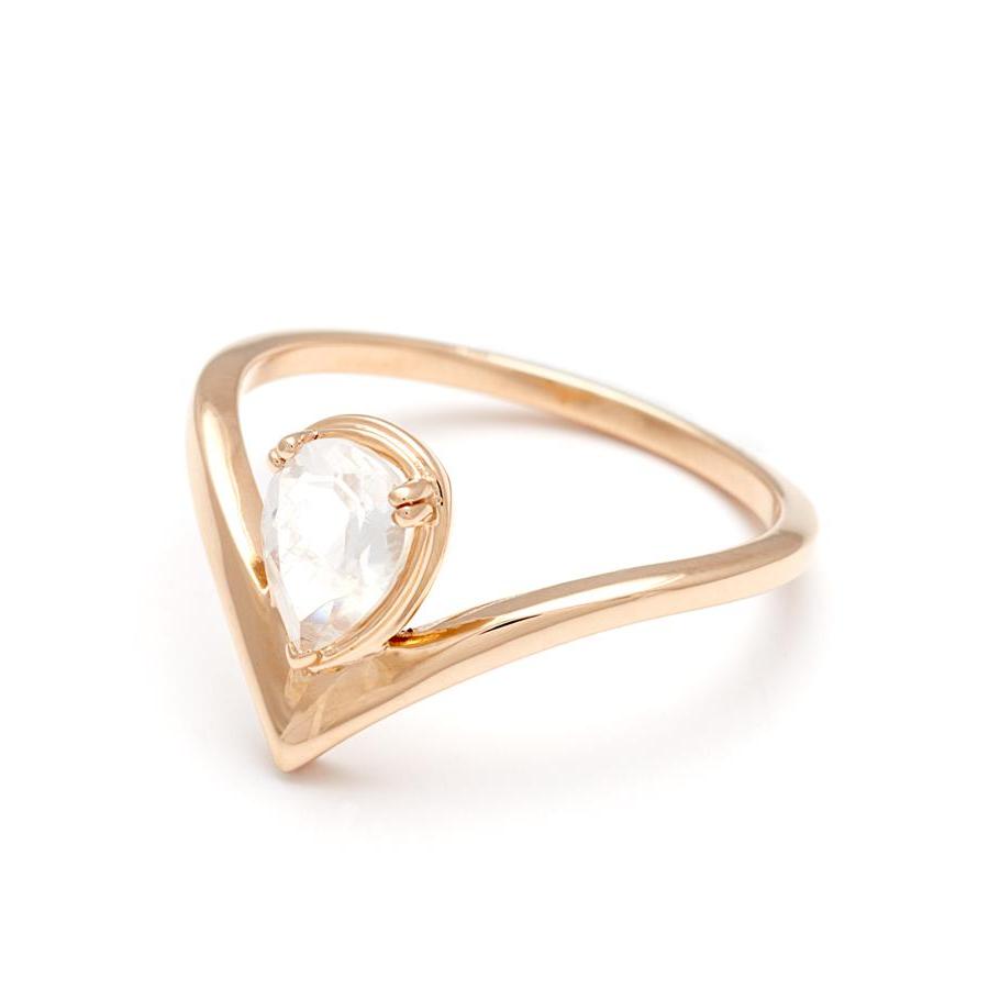 Angled view of a pear shaped ring with a black rutilated quartz center stone set in yellow gold.