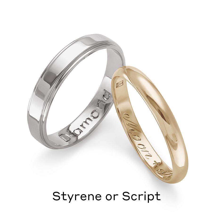 Two solid gold wedding bands one in white gold engraved with “Diamond” on the inside and one in yellow gold with “Moon + Stars” engraved on the inside.