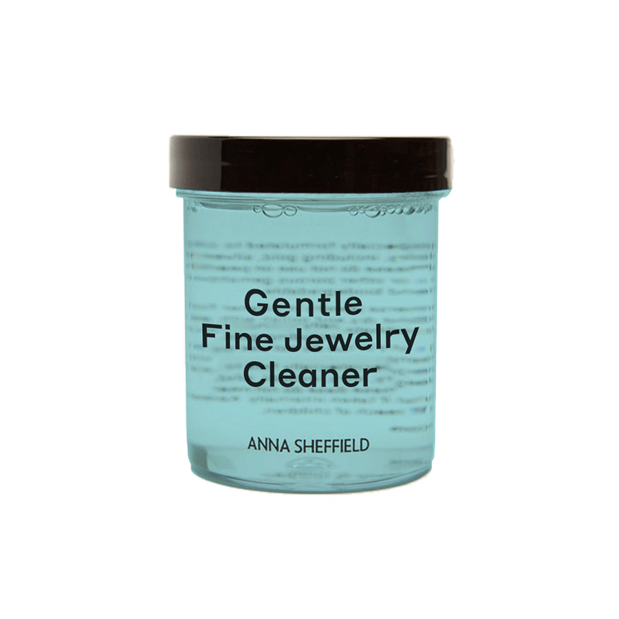 "Anna Sheffield Gentle Fine Jewelry Cleaner" in a small jar with blue liquid.