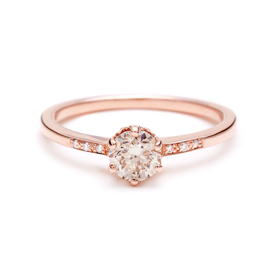 A solitaire ring with a brilliant cut 0.50ct champagne diamond with white diamond pave on either side set in rose gold., Rose Gold