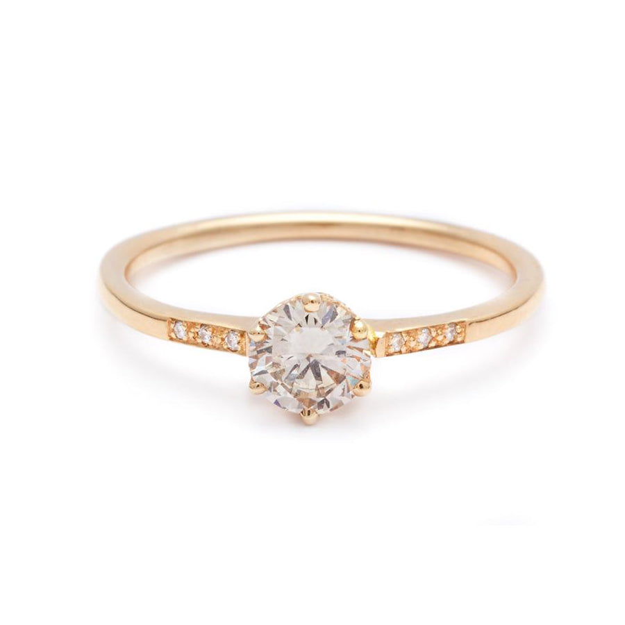 A solitaire ring with a brilliant cut 0.50ct champagne diamond with white diamond pave on either side set in yellow gold., Yellow Gold
