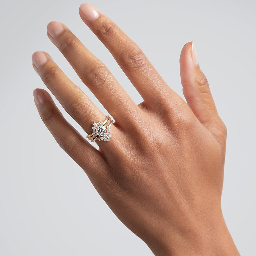 A solitaire white diamond ring stacked between two baguette diamond yellow gold bands on a medium-complexion hand., Yellow Gold, Rose Gold, White Gold