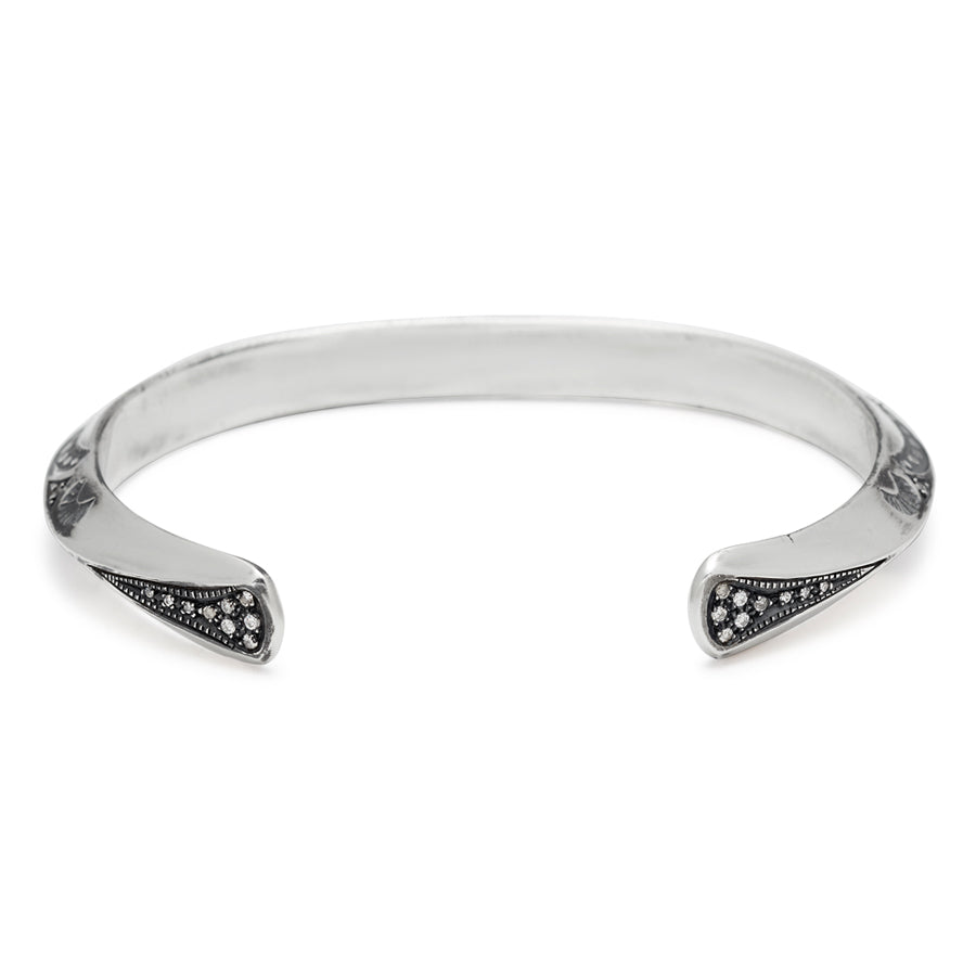 Upside down view of a bracelet cuff with moon shaped engravings set in sterling silver.