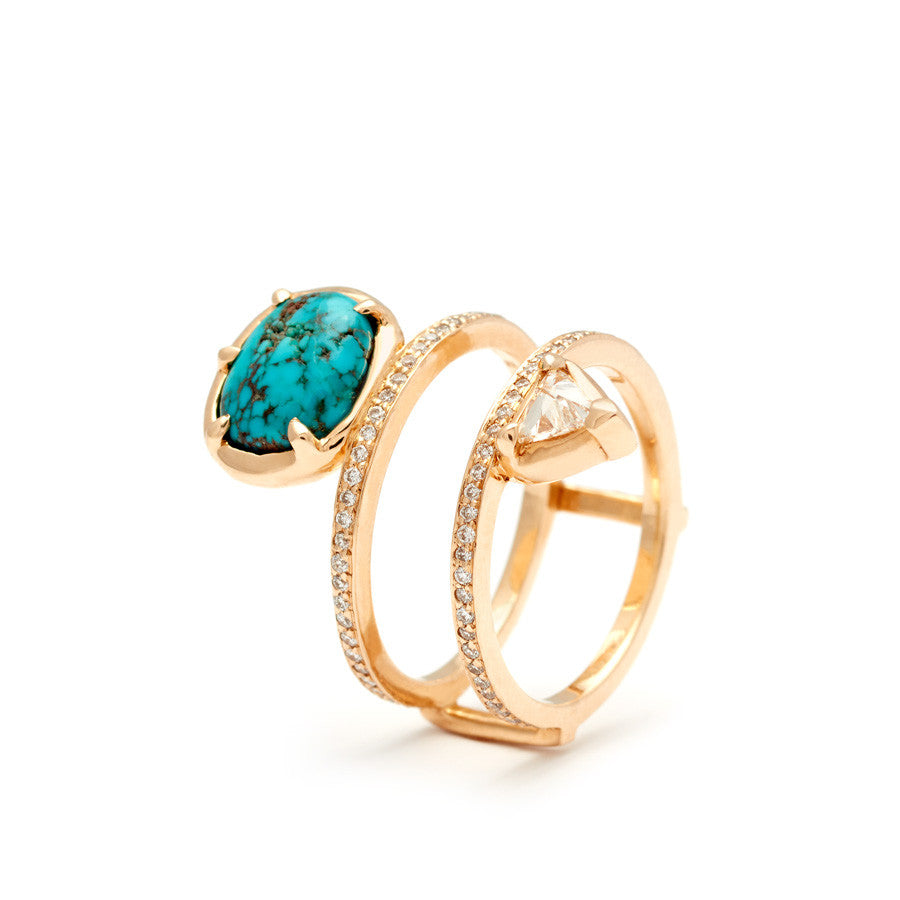 Angled view of a pair of medium pearl center stone earrings with a halo of white diamond set in yellow gold.