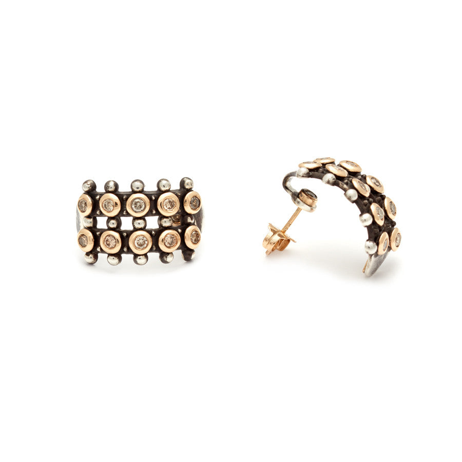 A pair of hoops with two lines of champagne diamonds set in sterling silver one angled earring.