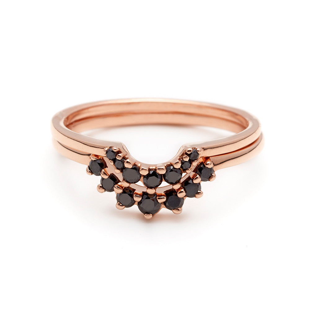 Two curved 7 black diamond bands set in rose gold, one with smaller diamonds and one with slightly larger diamonds.