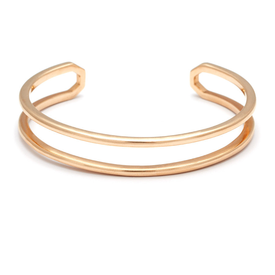 A doubled banded cuff bracelet set in yellow gold.