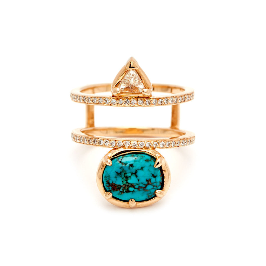 A double banded ring with white diamond pave around both bands with a champagne diamond trillion on the top and an oval turquoise stone set in bezel with claw prongs in yellow gold.