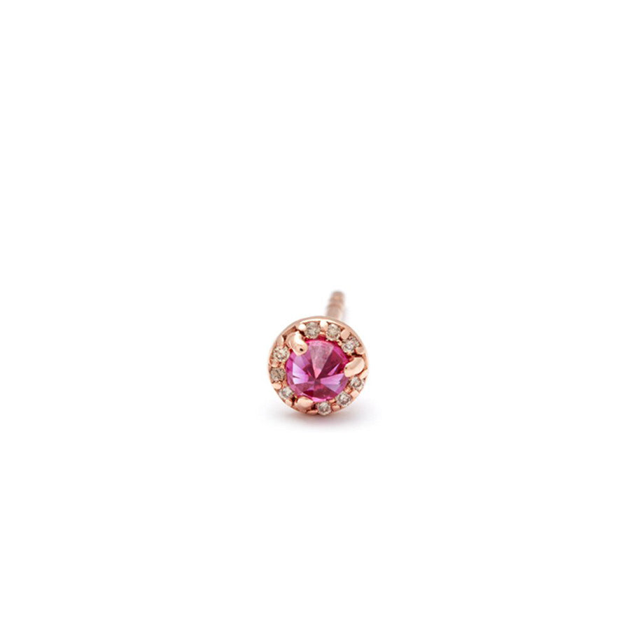 A single tiny ruby center stone earring with a halo of champagne diamond set in rose gold.