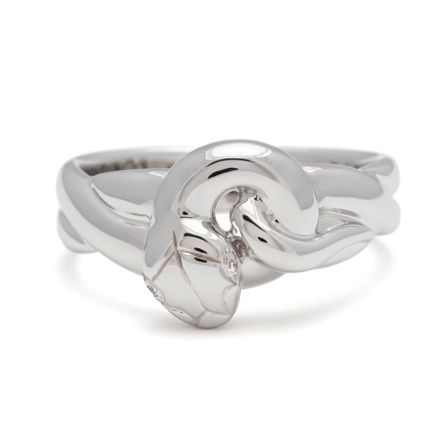 A large serpent band with white diamonds for eyes set in white gold., White Gold