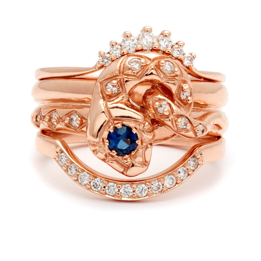 A serpent band with a blue sapphire center stone and white diamond accent stones around the head of the snake set in rose gold stacked between two white diamond curve bands in rose gold., White Gold, Rose Gold, Yellow Gold