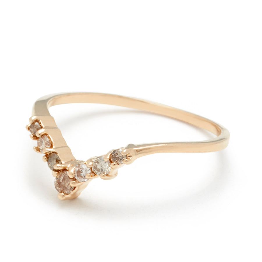 Angled view of a band with champagne diamonds in ascending size set in yellow gold.