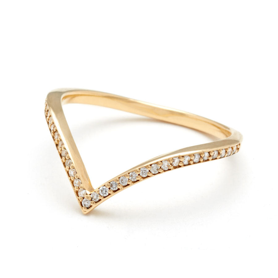 Angled view of a white diamond dusted chrysalis shaped band set in yellow gold.